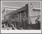 Workmen leaving the plant at the Vought Sikorsky Aircraft Corporation. Stratford, Connecticut.