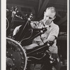 A workman on the final assembly of a Pratt and Whitney "WASP" engine. East Hartford, Connecticut.