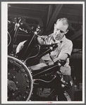 A workman on the final assembly of a Pratt and Whitney "WASP" engine. East Hartford, Connecticut.