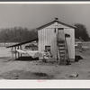 Tobacco barn converted into living quarters for families of workers from Fort Bragg. Near Fayetteville, North Carolina.