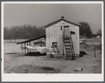 Tobacco barn converted into living quarters for families of workers from Fort Bragg. Near Fayetteville, North Carolina.