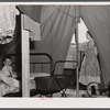 A family from the southern part of Texas occupies this tent. Husband works at Fort Bragg, but they expect to move on soon. In a settlement near Manchester, North Carolina.