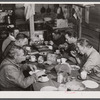 Migratory workers from Fort Bragg eating supper at a trailer settlement in Manchester, North Carolina.