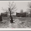 Children of a squatter family and the house in which they live in the Camp Croft area. South Carolina.