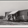 Building porch on prefabricated houses to be used to house some of the farmers that had to move out of Camp Croft area. Pacolet, South Carolina.