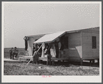 Building porch on prefabricated houses to be used to house some of the farmers that had to move out of Camp Croft area. Pacolet, South Carolina.