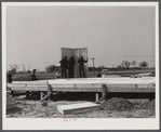 The first walls go up after the foundation has been built on prefabricated houses built by FSA (Farm Security Administration) to house some of the farmers who had to move out of the Camp Croft area region.