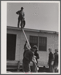 Putting the roof on a prefabricated house at the FSA (Farm Security Administration) project. Pacolet, South Carolina.