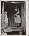 A tenant family in the Camp Croft area watching their belongings being moved out. Near Whitestone, South Carolina.