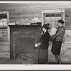 Mrs. Harvey and a neighbor watching her belongings being moved out of her house in the Camp Croft area near Whitestone, South Carolina.