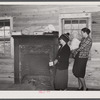 Mrs. Harvey and a neighbor watching her belongings being moved out of her house in the Camp Croft area near Whitestone, South Carolina.