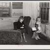 Children of a neighboring family who will also have to move out watch the movers at the home of the Harvey sisters in the Camp Croft area near Whitestone, South Carolina.