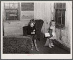 Children of a neighboring family who will also have to move out watch the movers at the home of the Harvey sisters in the Camp Croft area near Whitestone, South Carolina.