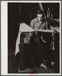 Tying together the thousands of separate strands for a loom in the Denomah Mills, Taftville, Connecticut. Makers of rayon and cotton cloth.