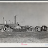 Fisherman's shacks in front of a mill along the waterfront in New Bedford, Massachusetts. Lobster traps in foreground.