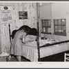 Fixing the curtains to be hung in their new prefabricated house at the home of the Hodge family. Pacolet, South Carolina.