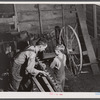 On a rainy day Mr. Lemuel Smith, FSA (Farm Security Administration) borrower, sharpens some of his co-operatively owned farm implements. Carroll County, Georgia (See general caption).