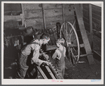 On a rainy day Mr. Lemuel Smith, FSA (Farm Security Administration) borrower, sharpens some of his co-operatively owned farm implements. Carroll County, Georgia (See general caption).