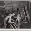 On a rainy day Mr. Lemuel Smith, FSA (Farm Security Administration) borrower, sharpens some of his co-operatively owned farm implements. Carroll County, Georgia (See general caption).
