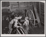 On a rainy day Mr. Lemuel Smith, FSA (Farm Security Administration) borrower, sharpens some of his co-operatively owned farm implements. Carroll County, Georgia (See general caption).