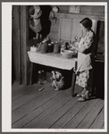Mrs. L. Smith still has some canned goods left over from the winter. Carroll County, Georgia (see general caption).