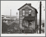 One of the houses in the [Black] quarter of Rochester, Pennsylvania. Abandoned glass works in background.