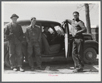 These men stopped at a trailer settlement to see about buying a trailer. They were very uncertain about how long their work would continue at Fort Bragg. Near Fayetteville, North Carolina.