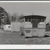 Abandoned school bus occupied by two workers from Fort Bragg, North Carolina in a settlement near the fort.