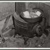 Washing dishes in a shack occupied by workers from Fort Bragg, North Carolina. Near Fayetteville.