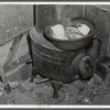 Washing dishes in a shack occupied by workers from Fort Bragg, North Carolina. Near Fayetteville.