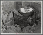 Washing dishes in a shack occupied by workers from Fort Bragg, North Carolina. Near Fayetteville.