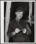 Silver Lake (vicinity), North Carolina. A worker who is employed at Fort Bragg in the doorway of a bunkerhouse in which he rents a lower berth.