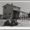 Woman fetching water. She lives with her family in lower part of the tobacco barn. Husband works at Fort Bragg. Near Fayetteville, North Carolina.
