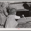Two of the Smith family children feeding the chickens. Carroll County, Georgia.