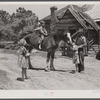 Colie Smith gets a ride on one of two horses owned by the Smith family. Carroll County, Georgia.