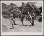 Colie Smith gets a ride on one of two horses owned by the Smith family. Carroll County, Georgia.