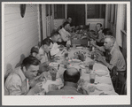 Workers from the powder plant having dinner at their boarding house. Childersburg, Alabama.