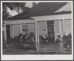 Workers from the nearby powder plant waiting for dinner on the porch of their boarding house. Childersburg, Alabama.