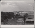 Landscape near one of the entrances to the powder plant near Childersburg. The dust in the back ground in caused by a great stream of traffic coming out of the powder plant. Alabama.