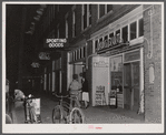 Soldier and his girl coming out of a restaurant in Anniston, Alabama.