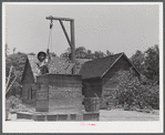 Allen Mathews drawing water from his well. FSA (Farm Security Administration) borrower. Near Greshamville, Greene County, Georgia.