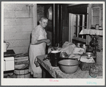 This woman is packing her belongings and getting ready to move out of the area taken over by the Army in Caroline County, Virginia.