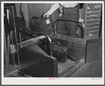 The baggage, after being weighed at the ticket counter, goes down a chute to the baggage department. Municipal airport, Washington, D.C..