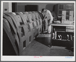 In the teletype room, where weather data and other information is constantly being received. Municipal airport, Washington, D.C..