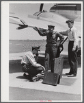 Using the field phone which connects with the administration building. Washington D.C. municipal airport.