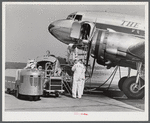 An airliner taking on baggage and fuel. Washington, D.C. municipal airport.