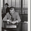 The C.A.A. announcer. He speaks from the central information desk and his voice is heard thru loudspeakers in every corner of the building and on the field. Municipal airport, Washington, D.C..