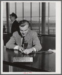The C.A.A. announcer. He speaks from the central information desk and his voice is heard thru loudspeakers in every corner of the building and on the field. Municipal airport, Washington, D.C..