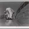 Checking the fuel of an airliner. Municipal airport, Washington, D.C..
