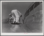 Checking the fuel of an airliner. Municipal airport, Washington, D.C..